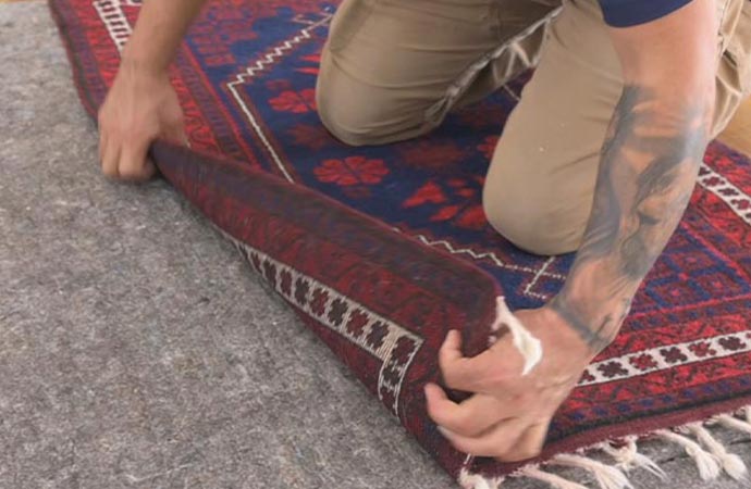 Worker replacing rug underlay